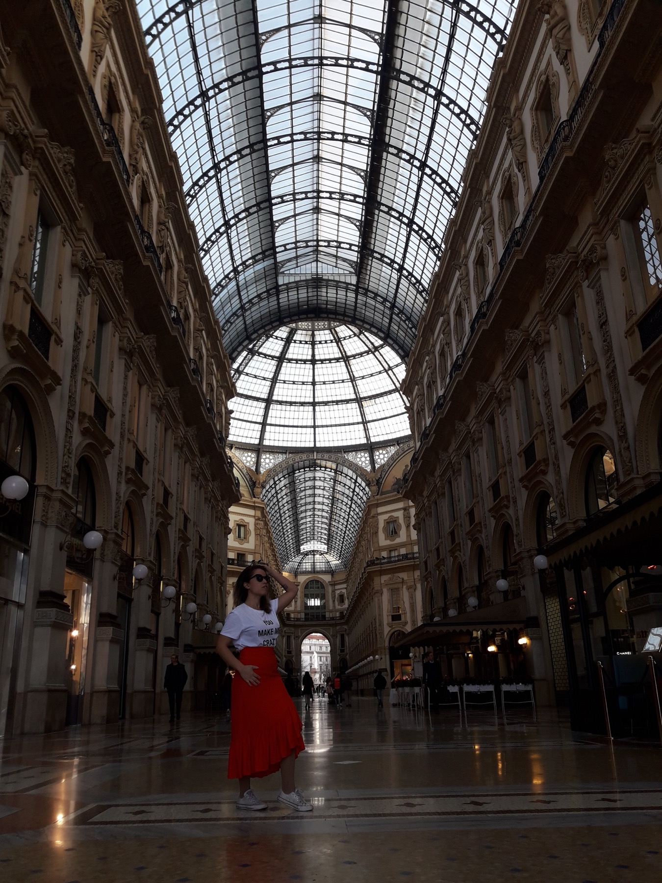 Giselle standing inside Milan's Galleria beneath its glass ceiling
