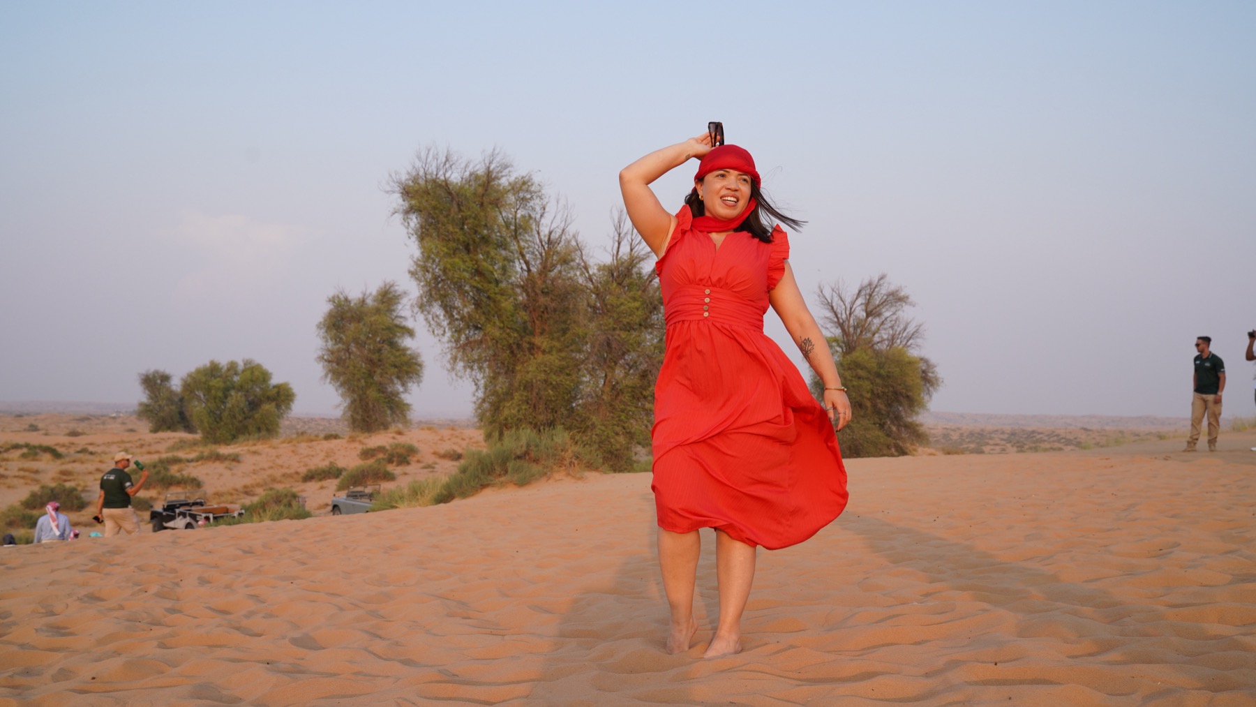 Giselle crossing desert dunes during golden hour