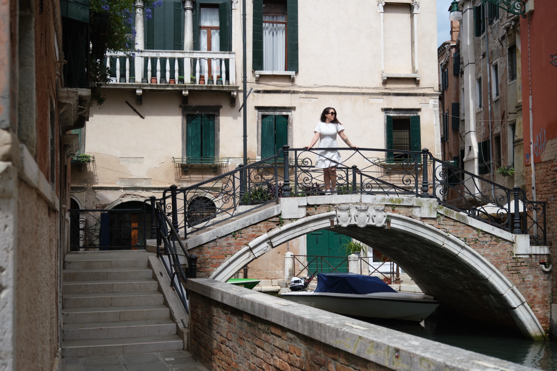 Giselle lifting her daughter beside a Venice canal